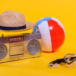 tape recorder, hat, beach ball and snorkel with scuba mask isolated on yellow