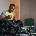 Male in room holding mask for scuba diving